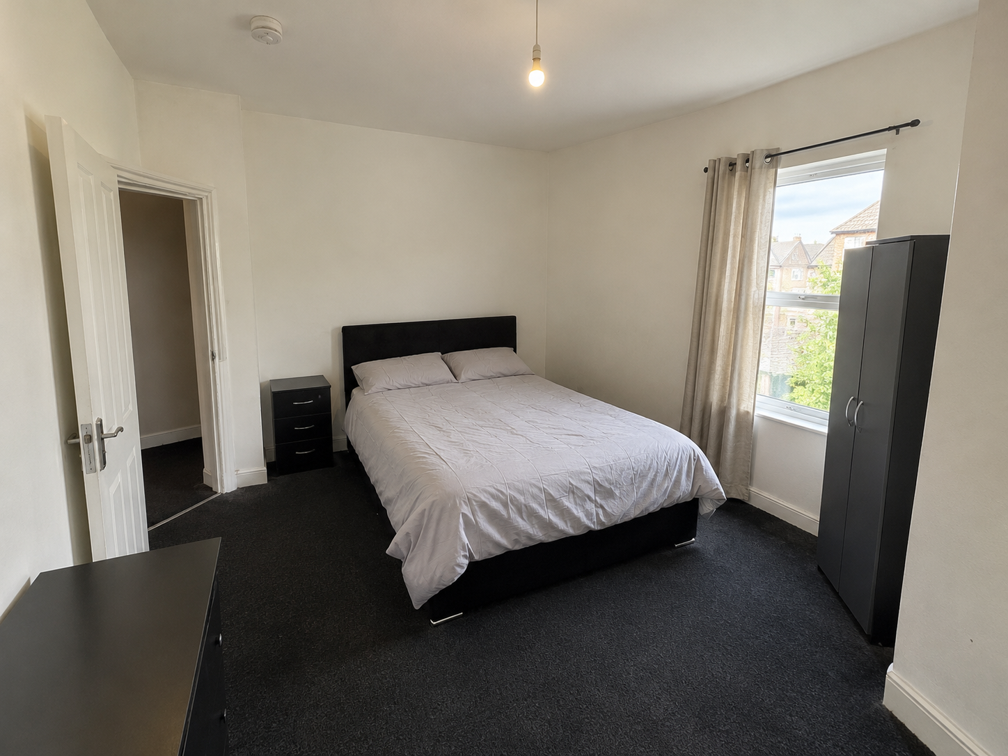 Henswood – Room 1: original photograph showing the double bed, bedside drawers, wardrobe and window