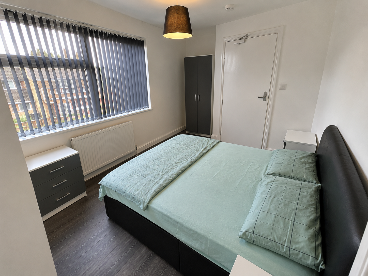 Kings Norton – Room 1: reverse view showing the double bed, window, wardrobe and doorway