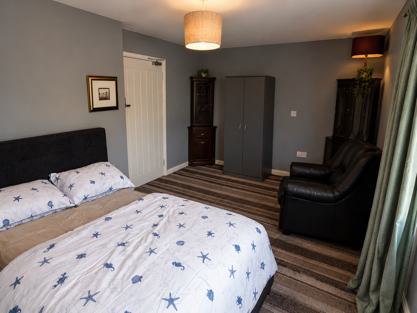 Castle Vale – Room 1: reverse view showing the bed, wardrobe and armchair