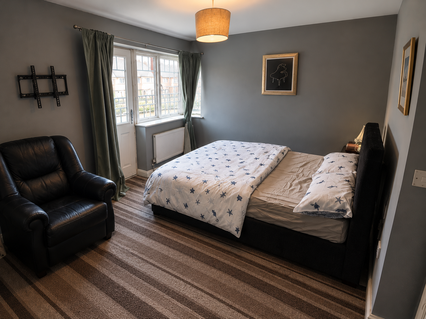 Castle Vale – Room 1: bedroom with double bed, armchair and window